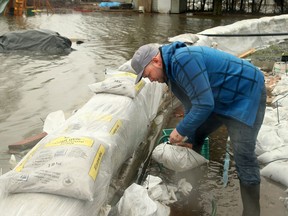 Kris Blais has been working around the clock since last week, running four pumps and building walls of sandbags around his sister and brother-in-law's home in Masson-Angers.