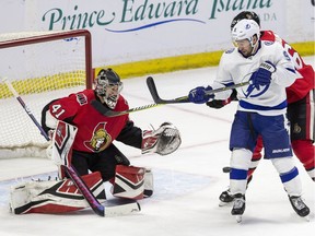 Ottawa Senators goaltender Craig Anderson prepares to make a save as Sens defence man #67 Ben Harper (obscured) defends against battles Tampa Bay Lightning #9 Tyler Johnson during NHL hockey action at Canadian Tire Centre in Ottawa on Monday