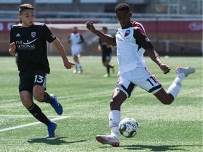 Mour Samb  of Ottawa Fury FC plays the ball forward past Alexon Saravia of Loudoun United during a United Soccer League Championship match at TD Place stadium in Ottawa on Saturday, April 12, 2019.