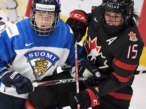 Nelli Laitinen (L) of Finland vies with Melodie Daoust of Canada during the semi-final match Finland v Canada at the IIHF Women's Ice Hockey World Championships in Espoo, Finland on April 13, 2019.