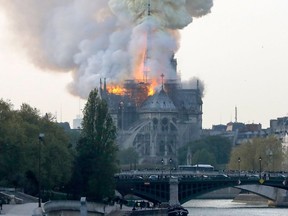 Smoke ascends as flames rise during a fire at the landmark Notre-Dame Cathedral in central Paris on April 15, 2019 afternoon, potentially involving renovation works being carried out at the site, the fire service said.
