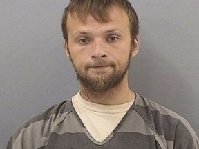 This undated booking photo provided by the Tennessee Bureau of Investigation shows Michael Cummins. Authorities say Cummins, 25, was taken into custody Saturday, April 27, 2019, in the investigation into several bodies found in two homes near Westmoreland, Tenn. Authorities say when the suspect Cummins was captured, he produced multiple weapons, prompting an officer to shoot him. Cummins was taken to a local hospital.