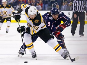 Brad Marchand of the Boston Bruins attempts to skate the puck away from Artemi Panarin of the Columbus Blue Jackets April 30, 2019 at Nationwide Arena in Columbus. (Kirk Irwin/Getty Images)