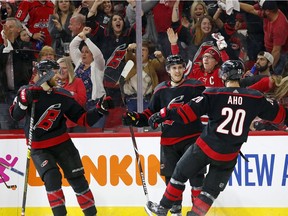 Carolina's Teuvo Teravainen (86) celebrates his goal against Washington in Game 4 on Thursday night with teammates Sebastian Aho (20) and Jacob Slavin (74).