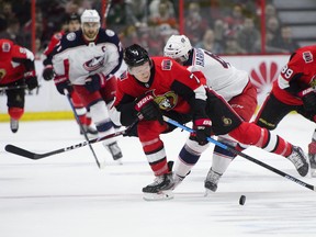 Senators’ Brady Tkachuk skates with the puck as Columbus Blue Jackets’ defenceman Scott Harrington gives chase last night in Ottawa. (THE CANADIAN PRESS)