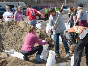 The community of Constance Bay gets busy filling sandbags to be used to protect their homes in anticipation of rising water from the Ottawa River.