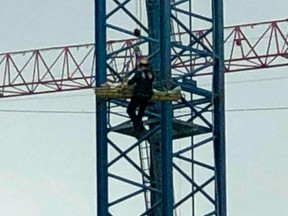 In this image take from video, Cincinnati Fire Department rescue a worker after his arm was partially severed in an accident nearly 300 feet up in the air, Friday, April 5, 2019, in Cincinnati.