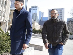 Galeeb Abau-Jabeen, left, enters court with his father after a smoke break on Thursday during his criminal negligence causing death and criminal negligence causing bodily harm trial in connection with a deadly 2016 crash on Bloor St. E. and Parliament.