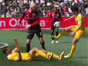 Ottawa Fury FC player Jérémy Gagnon-Laparé (8) is surrounded by Nashville Soccer Club players Kenneth Tribbett, left, and Kosuke Kimura (27) during a United Soccer League Championship match at TD Place stadium in Ottawa, ON. Canada on April 6, 2019. Nashville won the contest 3-0.