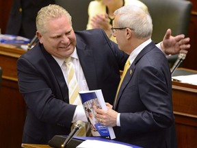 Ontario Finance Minister Vic Fedeli, right, is congratulated by Premier Doug Ford after presenting the 2019 budget at the legislature in Toronto on Thursday, April 11, 2019.
