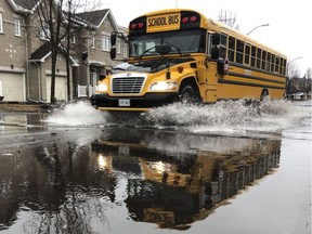 A school bus drives along a flooded Foxhall Way in Ottawa on April 15, 2019.