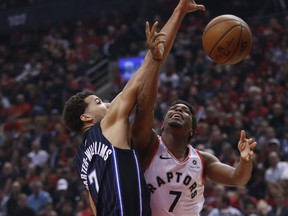 Orlando Magic’s Michael Carter-Williams (left) and Raptors’ Kyle Lowry battle for the ball during Game 2 of the first-round playoff series on Tuesday night in Toronto. (JACK BOLAND/TORONTO SUN)
