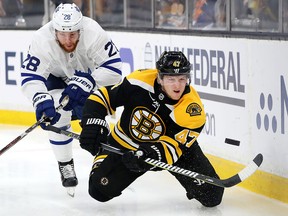 Torey Krug of the Boston Bruins dives for the puck while being pursued by Connor Brown of the Toronto Maple Leafs at TD Garden on April 19, 2019 in Boston. (Maddie Meyer/Getty Images)