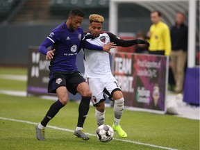 Kevin Oliveira, right, of Ottawa Fury FC tries to outduel Taylor Peay of Louisville City FC for possession of the ball during a United Soccer League Championship match at Louisville on Saturday, April 20, 2019. Louisville won 1-0.