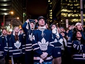 Fan react as the Toronto Maple Leafs lose to the Boston Bruins and are eliminated from the Stanley Cup playoffs in Toronto on Tuesday. Fans watched the action from Boston on large outdoor screens in Maple Leaf Square in Toronto.