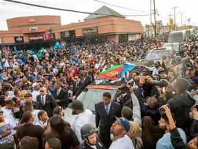 Nipsey Hussle's procession passes his Marathon Clothing store after his memorial at the Staples Center in Los Angeles on Thursday, April 11, 2019.