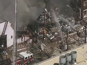 In this image taken from video firefighters and emergency officials respond to an explosion and fire in downtown Durham, N.C. on Wednesday, April 10, 2019. (WTVD-TV ABC 11 via AP)