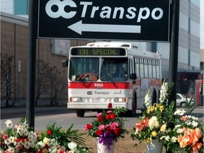 In April 1999, flowers sit under a sign outside the OC Transpo headquarters as a tribute to four employees who were killed by a disgruntled former employee.