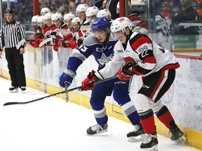 Liam Ross (left) of the Sudbury Wolves and Jack Quinn of the Ottawa 67's battle for the puck during OHL playoff action at the Sudbury Community Arena  on Tuesday night. (John Lappa/Sudbury Star)