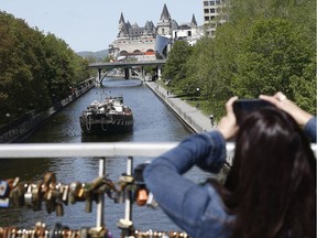 A boat travels up the Rideau Canal.