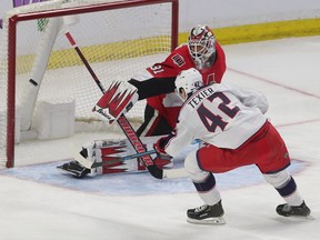 Ottawa Senators goalie Anders Nilsson tries to make a save against Alexandre Texier from the Columbus Blue Jackets during the second period on Saturday.