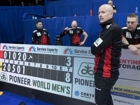 Canada skip Kevin Koe and Ted Appleman, B.J. Neufeld and Colton Flasch , rear left to right, are seen during the fifth end break in their game against Japan at the Men's World Curling Championship in Lethbridge, Alta. on Wednesday, April 3, 2019.