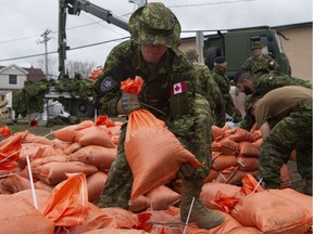 Members of the Canadian Forces prepare sandbags for distribution to residents threatened by floodwaters Wednesday April 24, 2019 in Gatineau, Que.