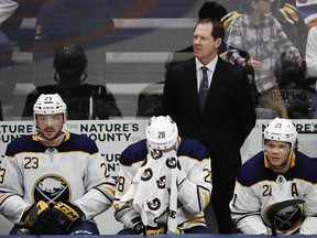 Sabres head coach Phil Housley, top, Sam Reinhart (23), Zemgus Girgensons (28) and Kyle Okposo (21) react during the third period of an NHL game against the Islanders, March 30, 2019, in Uniondale, N.Y.