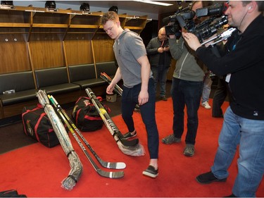 Brady Tkachuk steps around sticks and television camera persons as the Ottawa Senators wrap up their season by clearing out their lockers and head home.