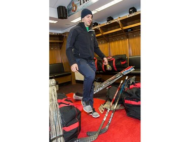 Dylan DeMelo steps over sticks and hockey bags as the Ottawa Senators wrap up their season by clearing out their lockers and head home.