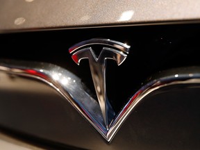 This Oct. 3, 2018, file photo shows a Tesla emblem at the Auto show in Paris.