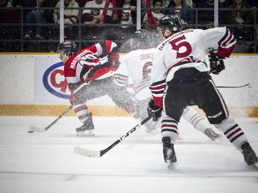 Ottawa 67's Kyle Maksimovich keeps the puck away from the Guelph Storm during the game at TD Place Arena on Saturday.