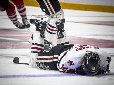 Guelph Storm's Nate Schnarr lay on the ice after getting hit in the face during the game against the Ottawa 67's at TD Place Arena on Saturday.