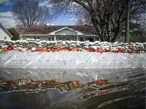 A wall of sandbags protects a home on Rue de Versailles.