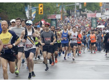 Runners leave the start line of the marathon at the Ottawa Race Weekend on Sunday, May 26, 2019.