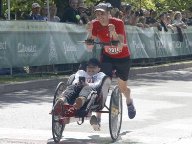 Jean-Philippe Morand, pushing, and Victor Morand finish the marathon in just under 3 hours at the Ottawa Race Weekend on Sunday, May 26, 2019.