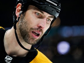 Zdeno Chara (top) has signed on for one more season with the Bruins.  AP