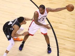 TORONTO, ONTARIO - MAY 25: Kawhi Leonard #2 of the Toronto Raptors handles the ball against Giannis Antetokounmpo #34 of the Milwaukee Bucks during the second half in game six of the NBA Eastern Conference Finals at Scotiabank Arena on May 25, 2019 in Toronto, Canada.