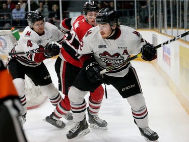 Guelph's Jack Hanley (front) battles with Ottawa's Jack Quinn behind Guelph's net in the first period.