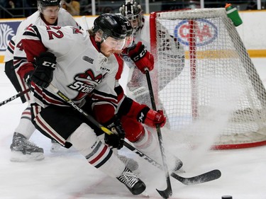 Guelph's Jack Hanley (front) battles with Ottawa's Jack Quinn behind Guelph's net in the first period.