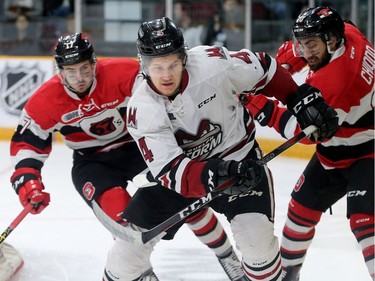 Guelph's Owen Lalonde (centre) swings around the back of his own net with the puck with Ottawa in pursuit during the Ottawa 67's matchup against the Guelph Storm in game five of the Eastern OHL final at TD Place in Ottawa Friday.