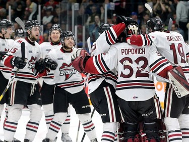 The Guelph Storm congratulate their goalie, Anthony Popovich for holding off the Ottawa 67's, who fell 4-3 to the Storm during their matchup in game five of the Eastern OHL final at TD Place in Ottawa on Friday.