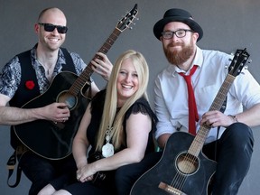 Singer Mags Gravelle, along with lead guitarist Matt Lytle (left) and singer/guitarist Tim Wilson, make up Karmacode's acoustic trio, which was playing The Bridge Public House May 8, 2019. At bigger gigs, the three join two other band members to play their Top-40 covers.