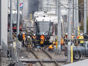 OC Transpo employees work on a train that derailed in the yards at 825 Belfast Rd. in Ottawa on Friday, May 3, 2019. Errol McGihon/Postmedia