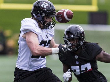 FB Gabriel Polan has the ball slip through his hands as LB Denzel Johnson closes in during Ottawa Redblacks rookie camp at TD Place on Wednesday, May 15, 2019.