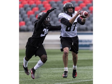 WR Seth Coate makes a catch as LB Tafon Mainsah defends during Ottawa Redblacks rookie camp at TD Place on Wednesday, May 15, 2019.