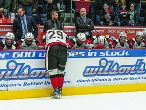 TYe Felhaber, playing his final game for the 67's, hangs his head leaning against the boards in front of a solemn team bench at the end of yesterday's 8-3 loss to the Storm in Guelph. The Storm took the OHl final 4-2 in games. (Gar FitzGerald photo)