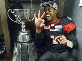 Ottawa Redblacks quarterback Henry Burris (1) wins the Grey Cup sitting in his locker with cigar and holding up three fingers for three cups  during CFL Grey Cup action in Toronto, Ont. on Sunday November 27, 2016.