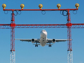 An Air Canada jet prepares to land at Pearson International Airport in Toronto, Thursday Sept. 30, 2004.