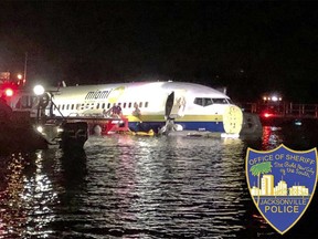 In this photo released by the Jacksonville Sheriff's Office, authorities work at the scene of a plane in the water in Jacksonville, Fla., Friday, May 3, 2019. (Jacksonville Sheriff's Office via AP)